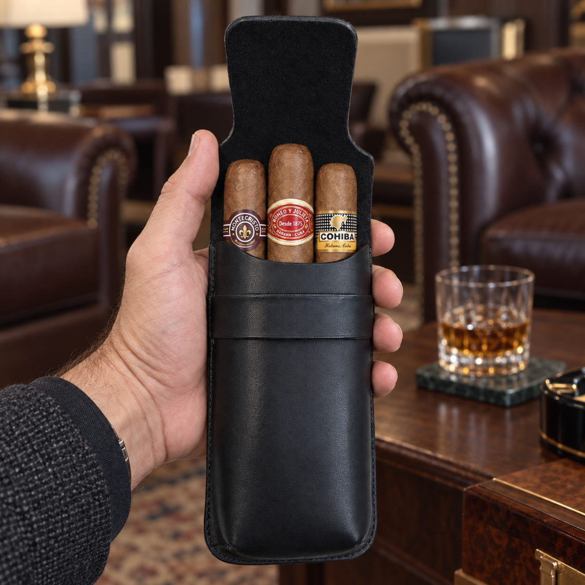 A hand holds a black leather cigar case containing three cigars, with a blurred luxury lounge setting in the background featuring leather sofas and a wooden table with a glass of whiskey.