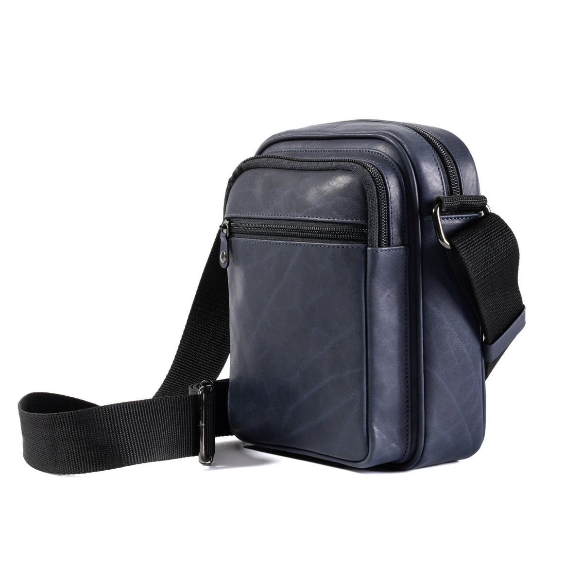 A dark navy blue leather crossbody bag with a black adjustable shoulder strap, shown from a three-quarters angle on a plain white background.
