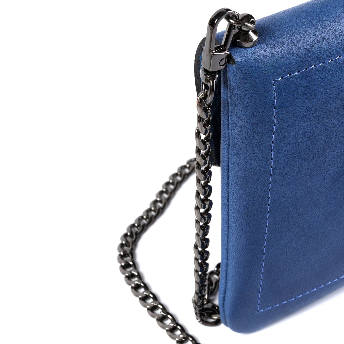 Close-up of a blue leather crossbody bag with a dark gunmetal chain strap and silver-tone clasp on a white background.