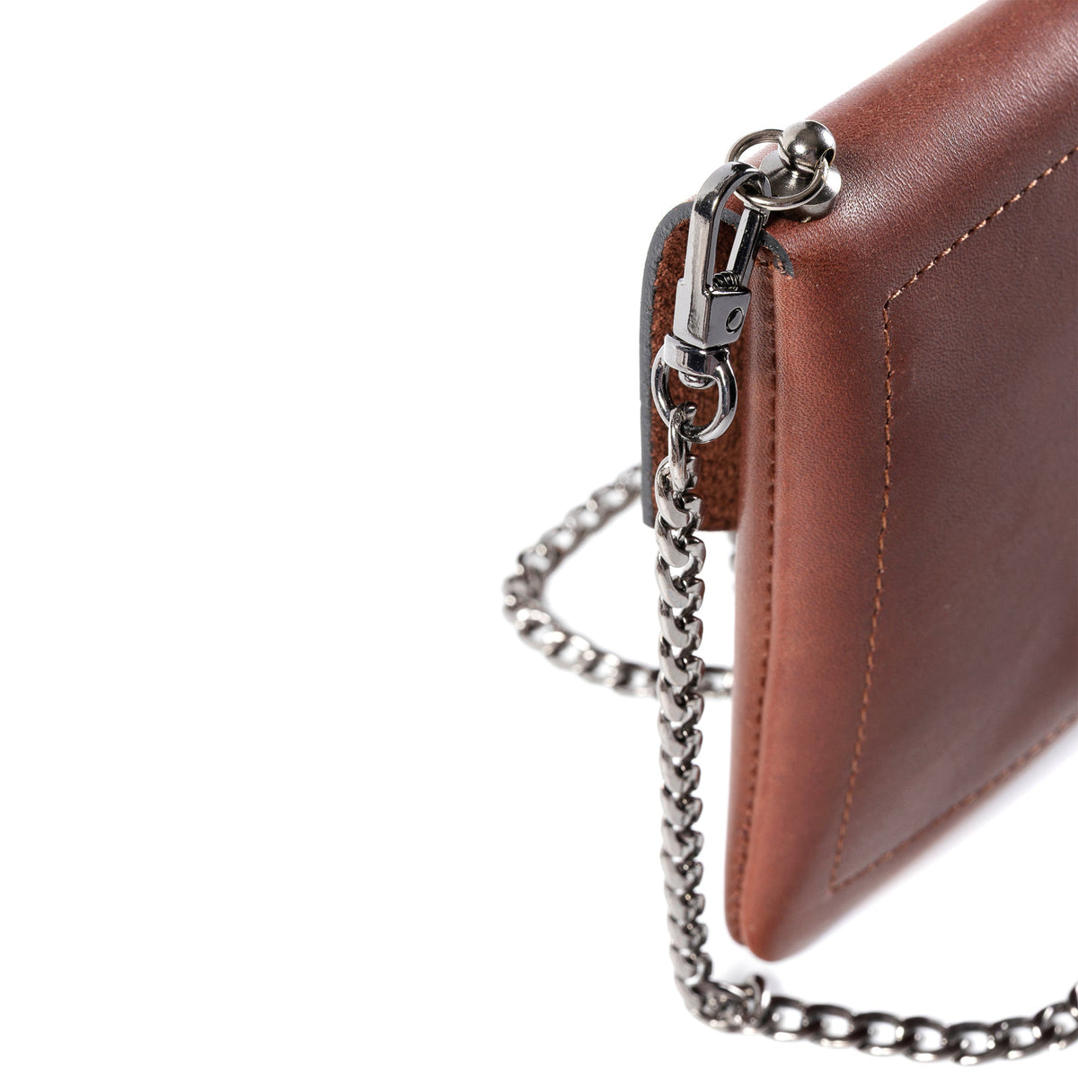 Close-up of a brown leather handbag corner with silver-tone chain strap and metal clasp on a white background.
