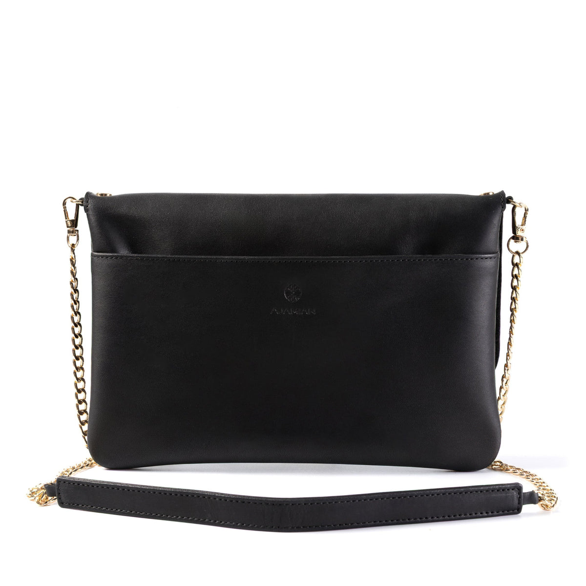 A black leather crossbody bag with a gold chain strap and a black wristlet strap, shown against a plain white background.