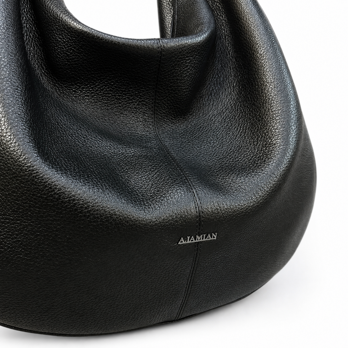 Close-up of a black pebbled leather slouchy shoulder bag with a small silver AIAMIAN logo on the front, set against a clean white background.
